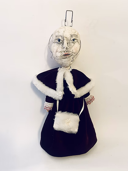 Hacked doll with a Kilner jar clip around its uncanny head